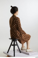    Aera  1 brown dots dress casual dressed sitting white oxford shoes whole body 0004.jpg